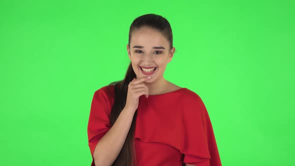 Portrait of Pretty Young Woman Confused Saying Oops and Shrugging. Green Screen alt