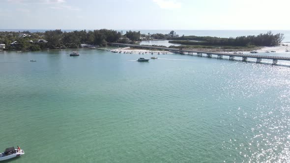 aerial of groups of boaters line the shores at Longboat Pass in Sarasota, Florida alt