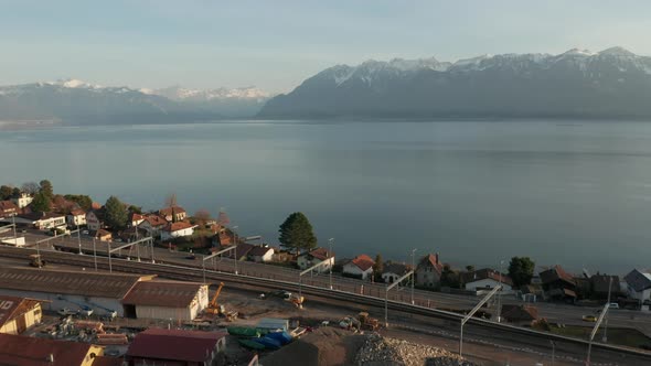 Aerial of highway at the edge of beautiful lake alt