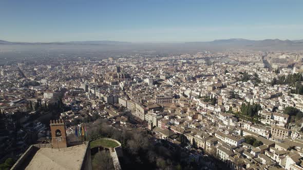 Impressive fortified palace of Alhambra overlooks city of Granada; aerial
