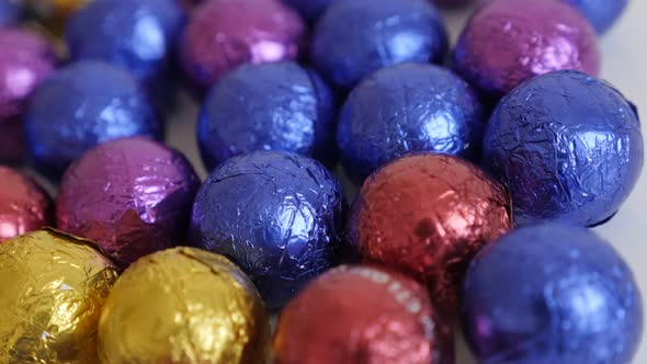 Lot of Christmas chocolate treats wrapped in cellophane slow pan  3840X2160 UltraHD footage - Backgr alt