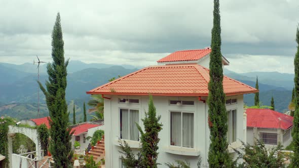 Rancho la vereda house and landscape in background, San Jose de Ocoa. Aerial pedestal up alt
