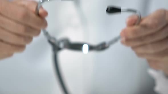 Doctor Putting on Stethoscope and Showing It to Camera, Regular Health Checkup