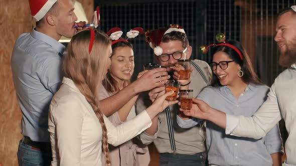 Young Colleagues Is Drinking Cocktails on Christmas Corporate Party in Office