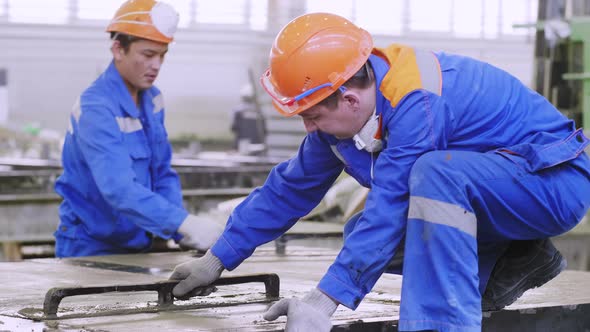 Manual labor workers at building factory