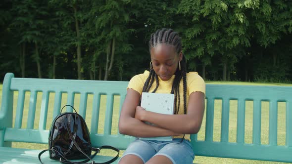 Sad Depressed Black Female Student Sitting on Bench After Failed Exam alt