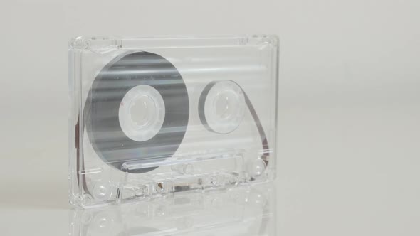 Close-up of transparent   analogue magnetic tape 4K 2160p 30fps UltraHD footage - Tilting on compact alt