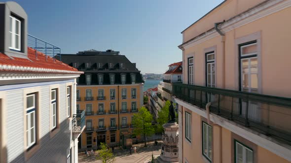 Drone Camera Flying in Top Floor Level Above Narrow Streets Towards Rivershore alt