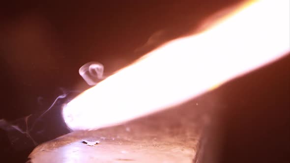 Striker sparking and lighting up torch flame. alt