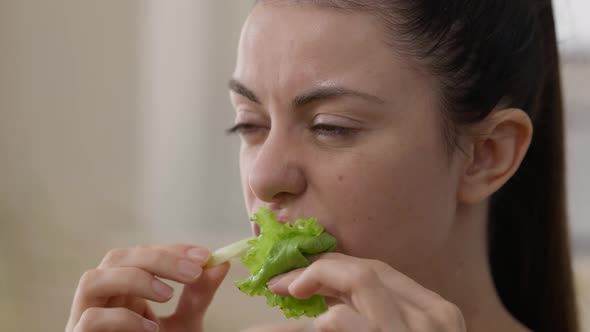 Closeup Face of Happy Young Vegan Woman Eating Green Salad Leaf Enjoying Taste alt