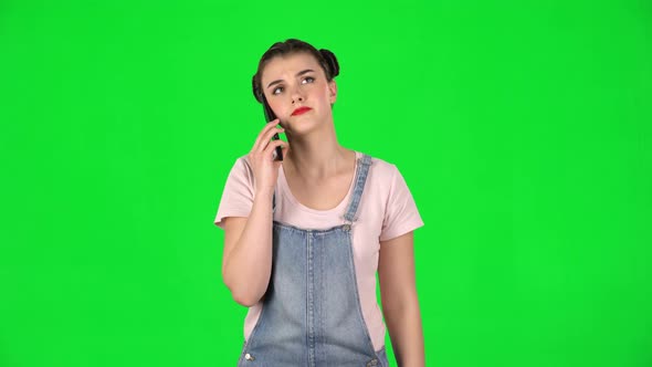 Portrait of Woman Speaking Via Telephone Looking Boredon Green Screen alt