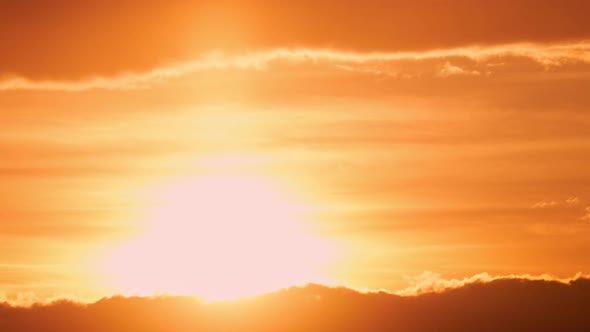 Dark clouds in the evening sunset sky with the setting sun, timelapse alt