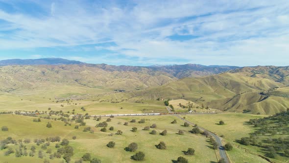 Train and Hilly Green Farmland, Kern County, California, USA, Aerial View