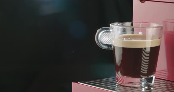 Espresso machine pours coffee into a cup. close-up alt