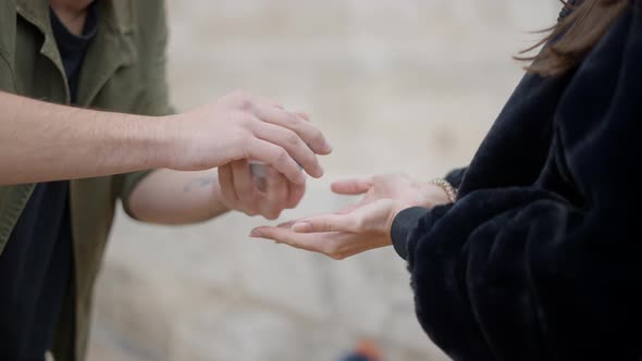 Professional Street Magician in a Cap Performs Sleight of Hand Card Trick alt