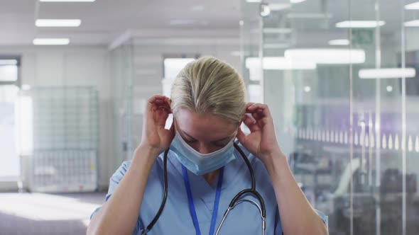 Portrait of female doctor wearing face mask in hospital alt