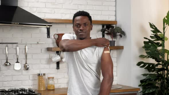 African American Man Patient Show Medical Plaster Demonstrates Vaccine Injection alt