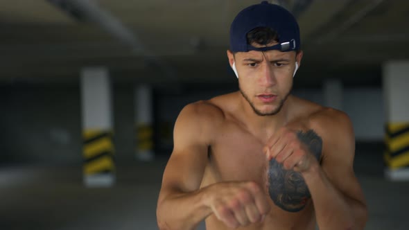 Sportsman Male Boxer Trains Speed and Coordination with a Tennis Ball alt