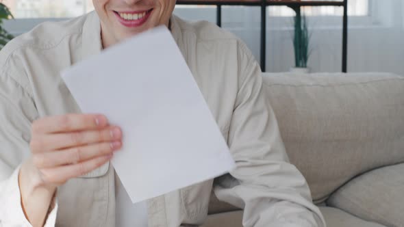 Smiling Happy Caucasian Man Millennial Guy Businessman Sitting Home Indoors Opens Envelope Reads alt