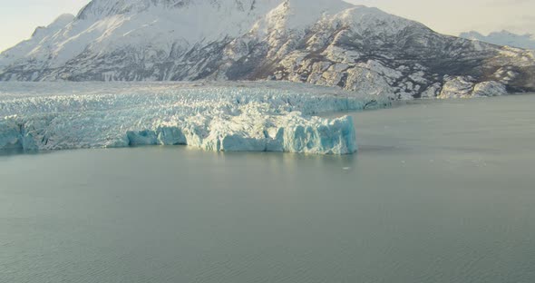 Aerial helicopter shot, overhead details of a craggy glacier, blue and white ice, drone footage alt