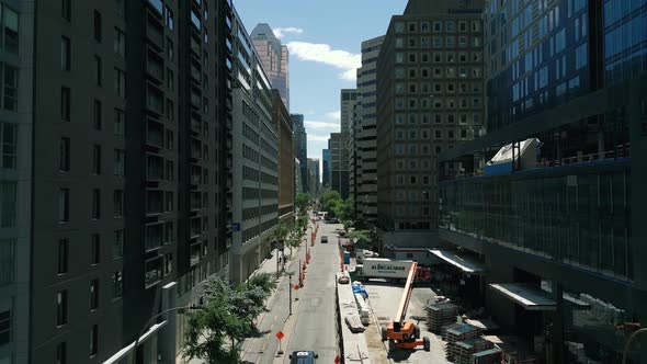4K Cinematic urban drone footage of an aerial view of a boulevard in the middle of downtown Montreal alt