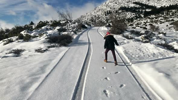 Small Girl Having Fun On Snow Covered Road 