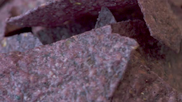 Macro slide across a bowl of delicious, crunchy, blue nachos. alt