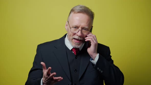 Nervous middle aged businessman with a cellphone alt