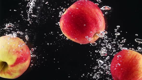 Ripe Apples Falling Through Water alt