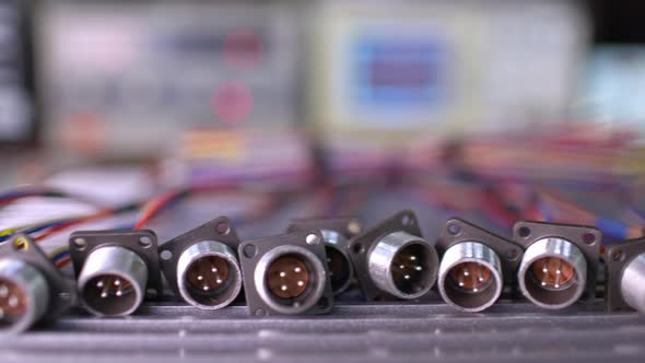 Slider Shot Video of Blurry Metal Sockets for Plugs alt