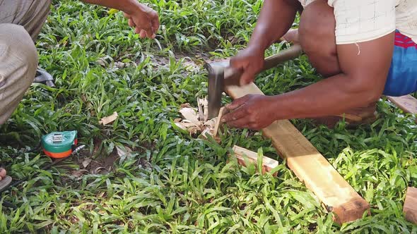 Slow Motion Shot of a Men Shaving a small piece of wood With Axe alt