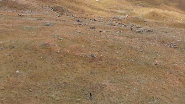 Tilt Up View Of Hiker Passing In Scenic Valley alt