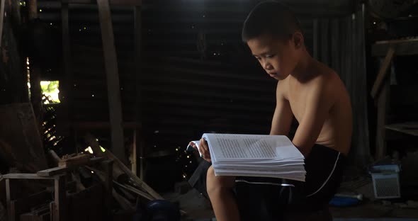 Poor Boy Reading Book In His House alt