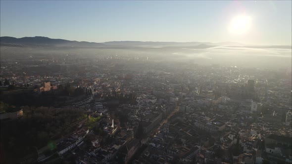Stunning aerial flight over historic city of Granada at magic hour; Spain
