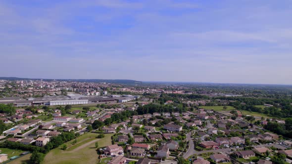 Outskirts of Montauban Southern France with residential and industrial areas, Aerial pan right shot alt