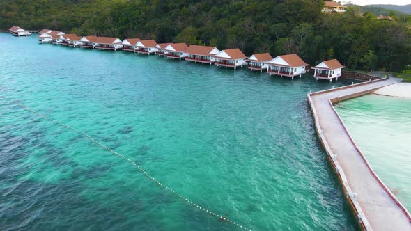 Sunlight Ecotourism Island Resort Clear Green Waters Stilt Houses Aerial Drone Push-In alt