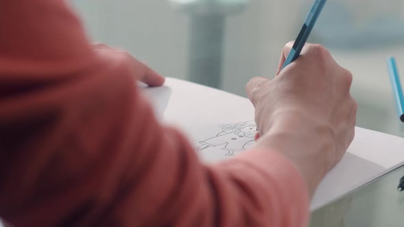 Young Asian Pregnant woman drawing baby in belly and family in notebook alt