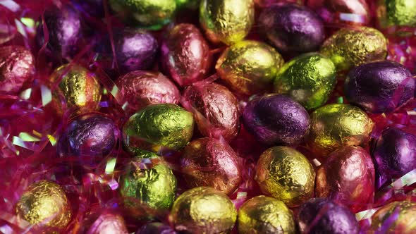 Rotating shot of colorful Easter candies on a bed of easter grass  alt