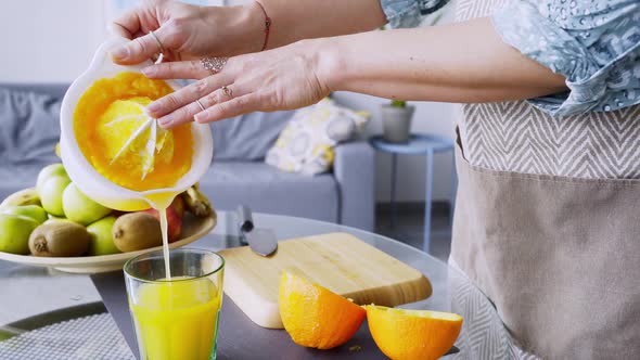 Woman Prepare Fresh Orange Juice at Home