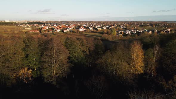 Aerial Reveal Shot of Many Small Modern Houses Near River alt