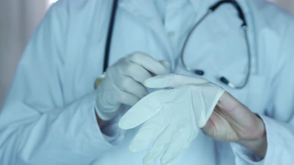 Doctor Puts Medical Gloves