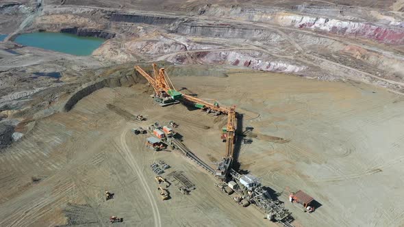 Aerial View, Lignite Coal Open Pit Mine and Heavy Machinery on Sunny Day, Orbit Drone Shot 50fps alt
