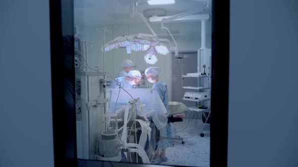 Medical Team Performing Surgical Operation in Bright Modern Operating Room alt