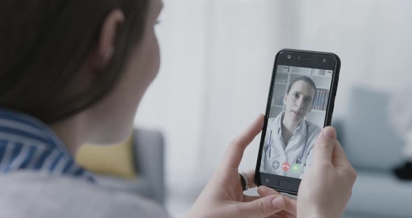 Woman video calling her online doctor, telemedicine concept