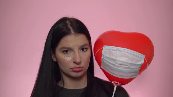 Woman Hold Heart Shape Balloon in Mask