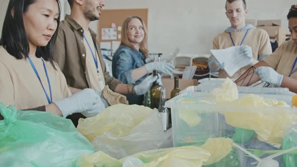 Volunteers Sorting out Rubbish into Containers alt