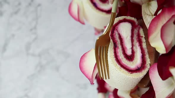 Breaking Raspberry Roll Cake With Fork