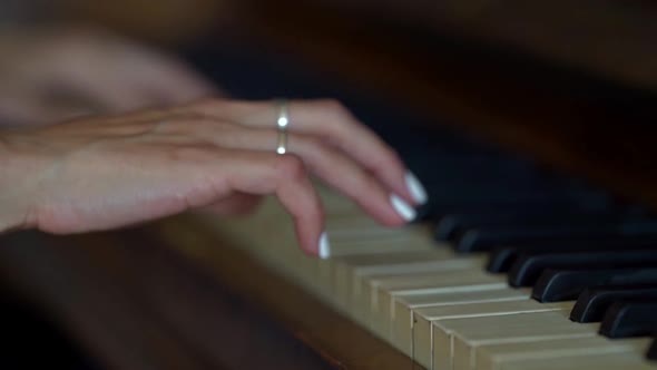 Woman Is Playing Fortepiano, Closeup of Female Hands on Keys, Fingers Are Touching alt