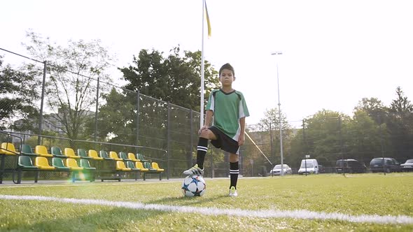 Sport Boy Looking to the Camera and Possing with Soccer Ball alt