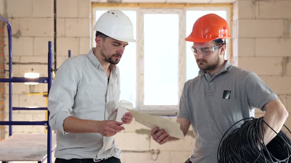 An engineer and a builder are discussing a construction plan.